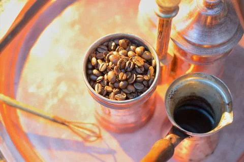 Close up coffee beans to in a copper container on a dark background Stock Photos