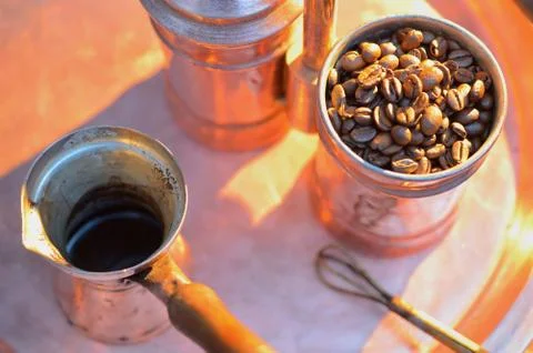 Close up coffee beans to in a copper container on a dark background Stock Photos