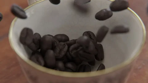 Close up of Coffee beans falling into a cup in slow motion Stock Footage 253627066