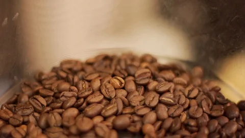 Close up of coffee beans falling into glass container in slow motion, Portugal Stock Footage 129068252