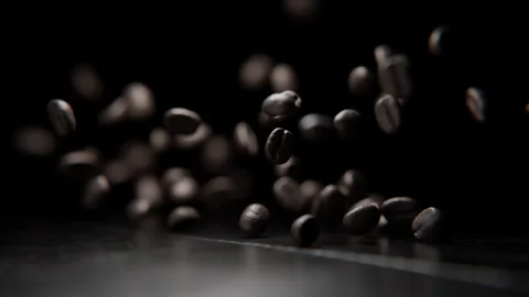 Close up of Coffee beans falling on a table Stock Footage 253626270