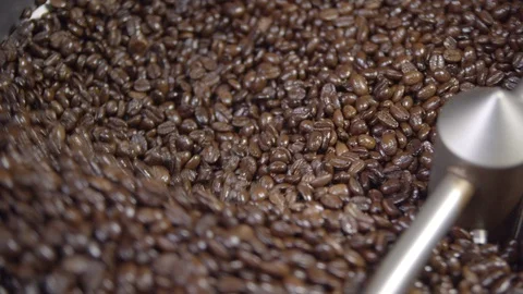 Close up of coffee beans rotating in roaster in slow motion, 4k Stock Footage 112295142