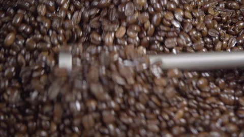 Close up of coffee beans rotating in roaster in slow motion, 4k Stock Footage 112295207