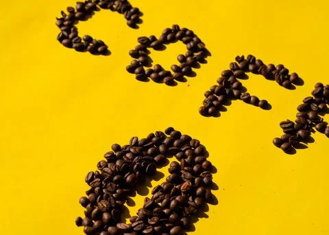 Close-up of coffee beans in the shape of letters that can be read "coffee" an Stock Photos
