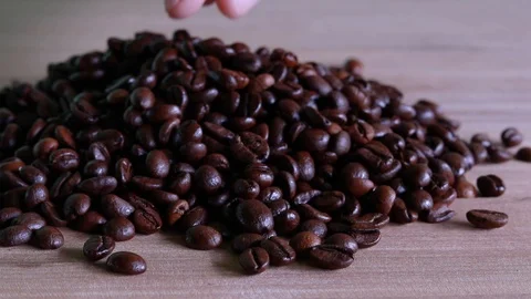 Close up of coffee beans shooting over wooden background. Stock Footage 95238174