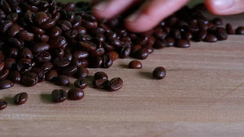 Close up of coffee beans shooting over wooden background. Stock Footage 95238201