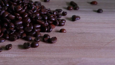Close up of coffee beans shooting over wooden background. Stock Footage 95238271