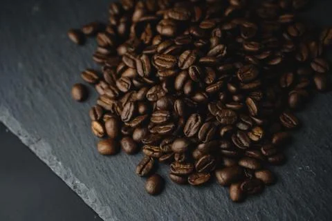 Close up Coffee beans on a slate texture. Isolated dark background. Celebrate Stock Photos