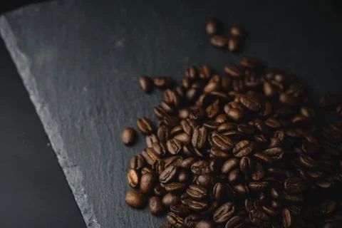 Close up Coffee beans on a slate texture. Isolated dark background. Celebrate Stock Photos