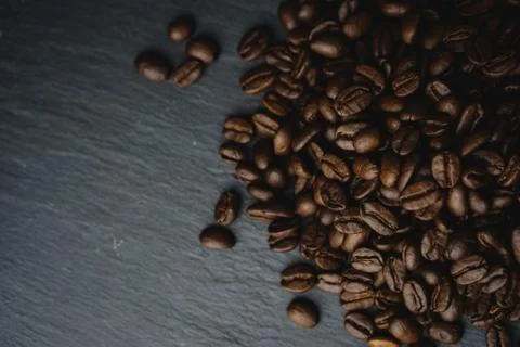Close up Coffee beans on a slate texture. Isolated dark background. Celebrate Stock Photos