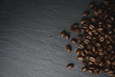 Close up Coffee beans on a slate texture. Isolated dark background. Celebrate Stock Photos