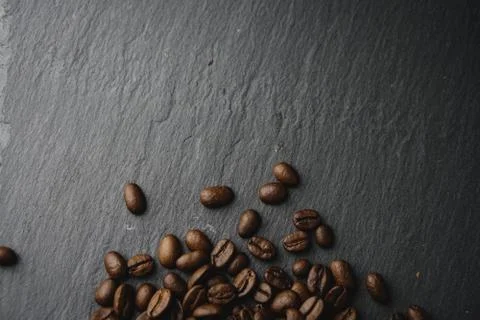 Close up Coffee beans on a slate texture. Isolated dark background. Celebrate Stock Photos