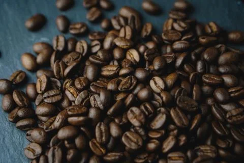 Close up Coffee beans on a slate texture. Isolated dark background. Celebrate Stock Photos