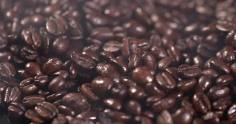 Close-up of coffee beans in slow motion lie on a black background Stock Footage 130361613