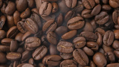 Close-up coffee beans with smoke are roasted and rotated Stock-Footage 129574759