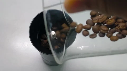 Close-up of coffee beans sprinkled in a coffee grinder Stock Footage 318352204