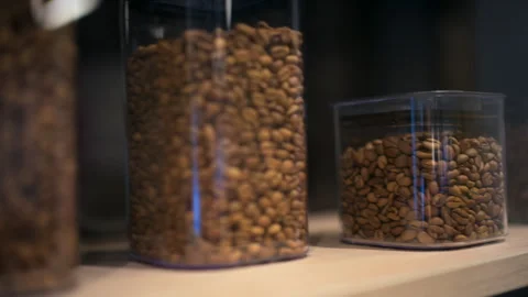 Close up of coffee beans stored inside transparent containers of different Stock-Footage 329393498