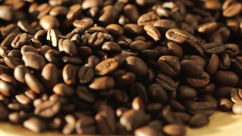 Close up of coffee beans on a wooden surface Stock Footage 302261552