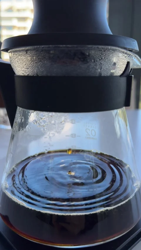 Close-up of a coffee brewing carafe with dark brewed coffee Stock Footage 297373553