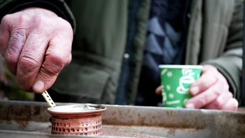 Close-Up of Coffee Brewing in a Cezve on Sand Stock Footage 303486281