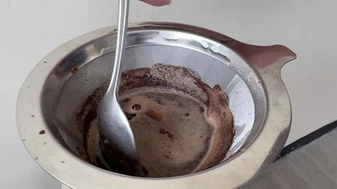 Close Up Of Coffee Brewing Process In A Metal Filter Using A Spoon Stock Footage 313542562