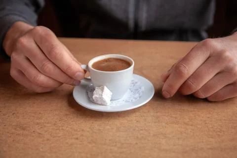 Close-up of coffee cup and hands on a table Stock Photos