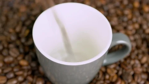 Close up coffee cup being filled up with coffeebeans Stock Footage 116270937