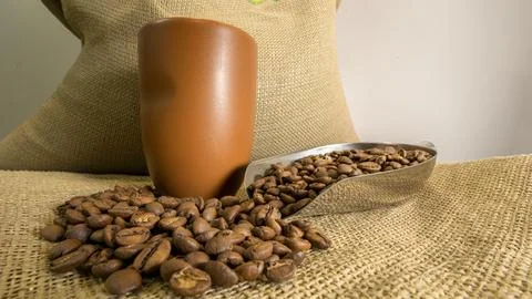 Close up of coffee cups with coffee beans on coffee sackcloth Stock Photos