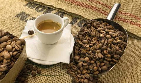 Close up of coffee cups with coffee beans on coffee sackcloth Stock Photos