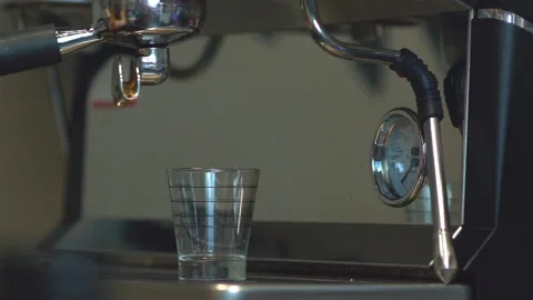 Close up coffee extraction on espresso machine in measuring cup Video stock 99116054