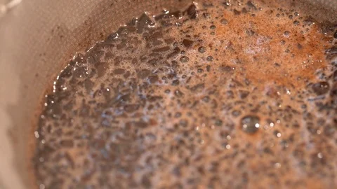 Close up of coffee grinds soaking up water and making coffee Stock Footage 125469909