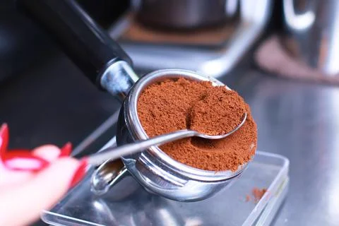 Close-up, coffee holder on the kitchen scale, ground coffee beans in the filter Stock Photos