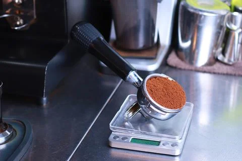 Close-up, coffee holder stands on the kitchen scale, ground coffee beans in the Stock Photos