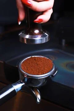 Close-up, coffee holder on the table, ground coffee beans in the filter Stock Photos