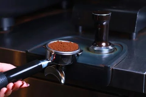 Close-up, coffee holder on the table, ground coffee beans in the filter Stock Photos