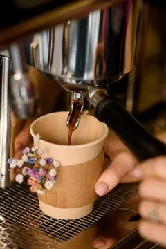Close-up of coffee machine and hot coffee drink flowing into paper cup under the 스톡 사진