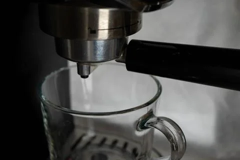 A close-up of a coffee machine with a coffee cup, capturing the anticipation Stock Photos