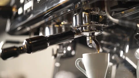 A close-up of a coffee machine with a cup and coffee pouring into it Stock Footage 102303947