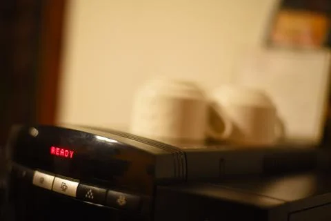 Close up of a coffee machine with cups on top Stock Photos
