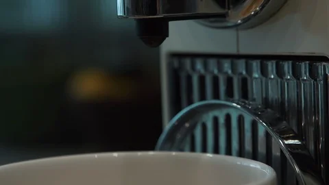 Close up of a coffee machine dispensing fresh hot coffee into a cup Stock Footage 127322535