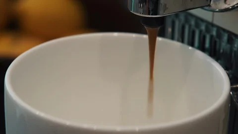 Close up of a coffee machine dispensing fresh hot coffee into a cup Stock Footage 127322757