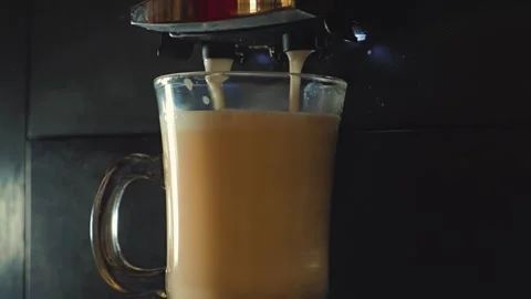 Close-up of a coffee machine pouring a fresh cappuccino Stock Footage 346471796