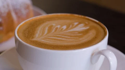 Close up of coffee made by a barista with a pattern on the surface. Stock Footage 105646491