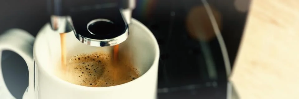 Close up of coffee maker machine pouring brewed hot Espresso Stock Photos