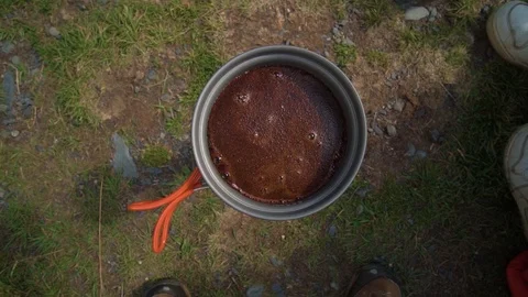 Close-up of a coffee maker. Preparing coffee on burner in mountains. Video stock 121859942