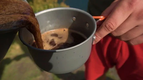 Close-up of a coffee maker. Preparing coffee on burner in mountains. Video stock 121859978