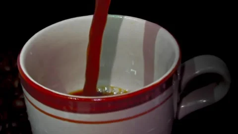 Close-up of Coffee Pour Into Cup with black background. Stock Footage 323781955