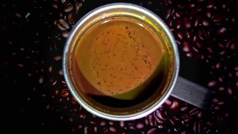 Close-up of Coffee Pour Into Cup with black background. Stock Footage 323782045