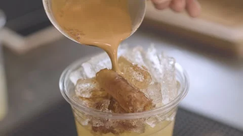 Close Up of Coffee Pouring Into Ice Filled Cup Stock Footage 342016062