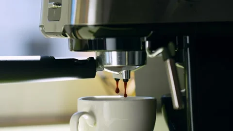 Close-up of coffee pouring from a machine into a cup. 스톡 동영상 282993431